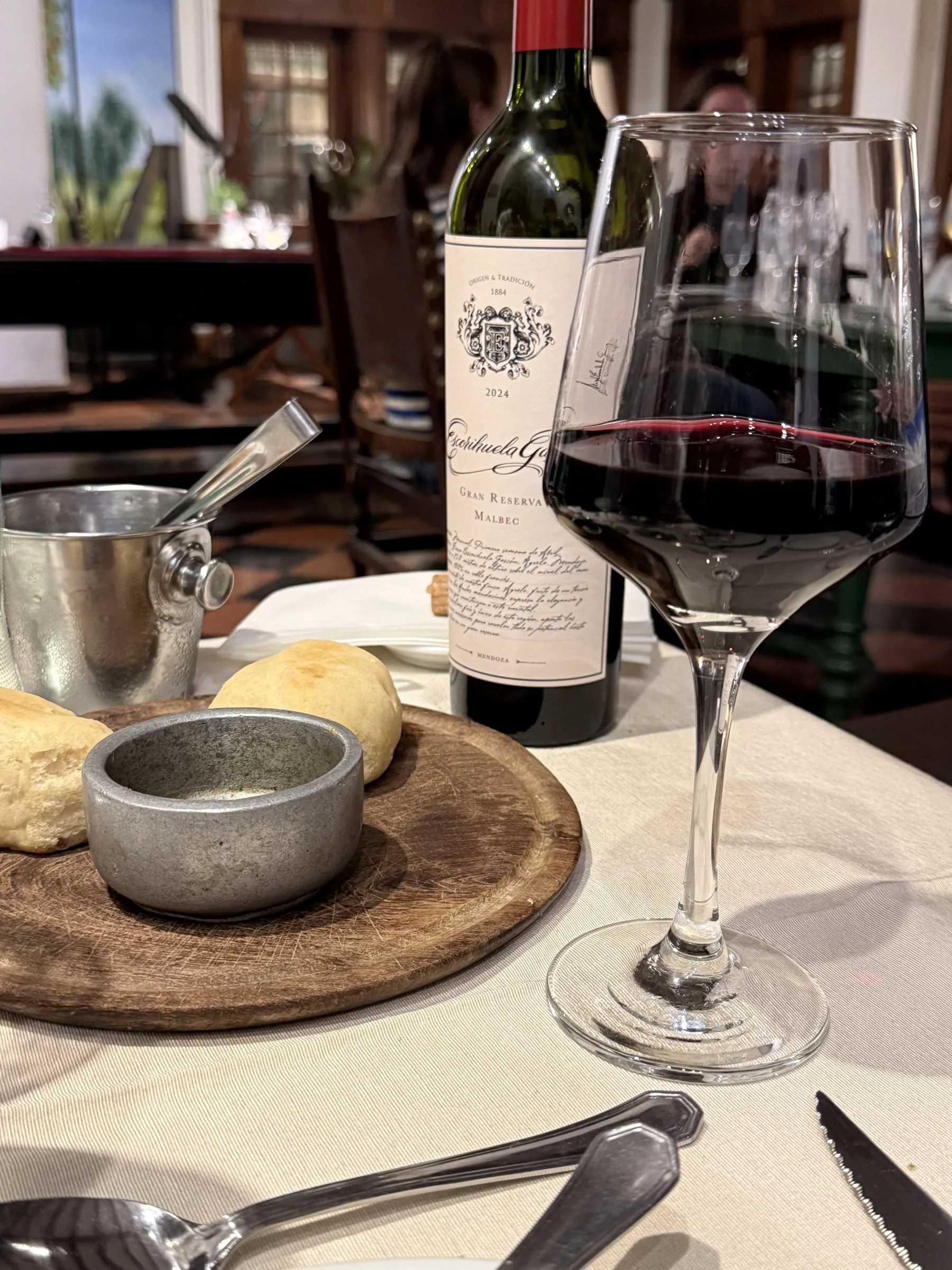 A glass of Malbec served with bread at Estancia Villa María