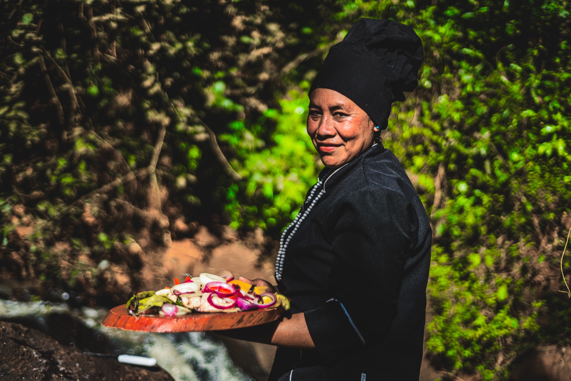 A local chef presenting Misiones flavours beside a jungle stream