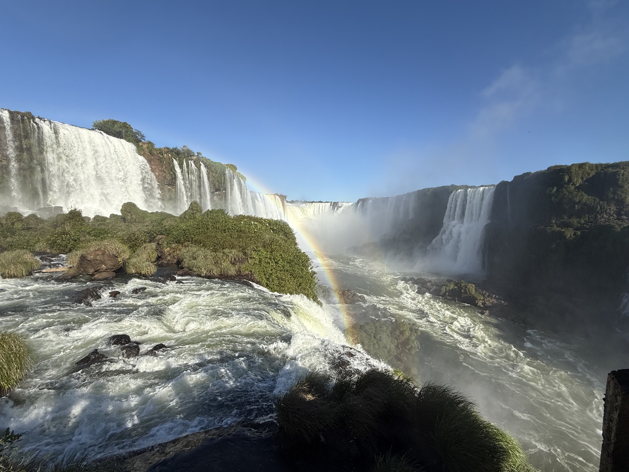 A rainbow rising from the mist over Iguazú Falls