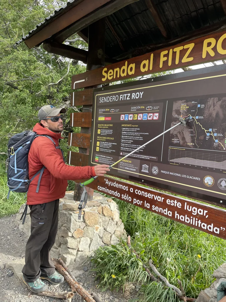 A mountain guide explaining the Fitz Roy trail map