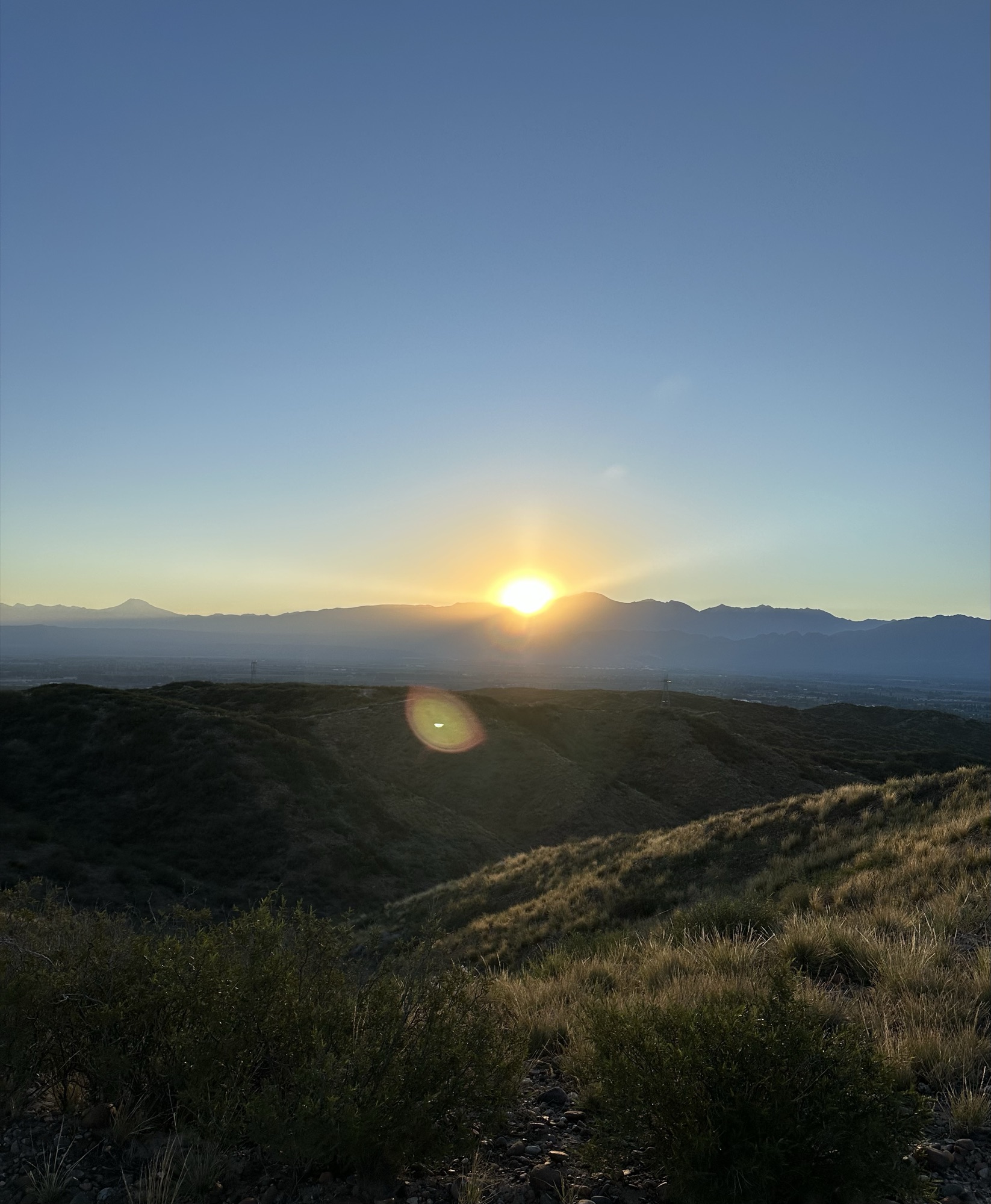 The sun setting behind the Andes above the Mendoza valley
