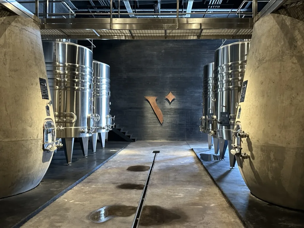 A contemporary winery cellar lined with stainless steel tanks
