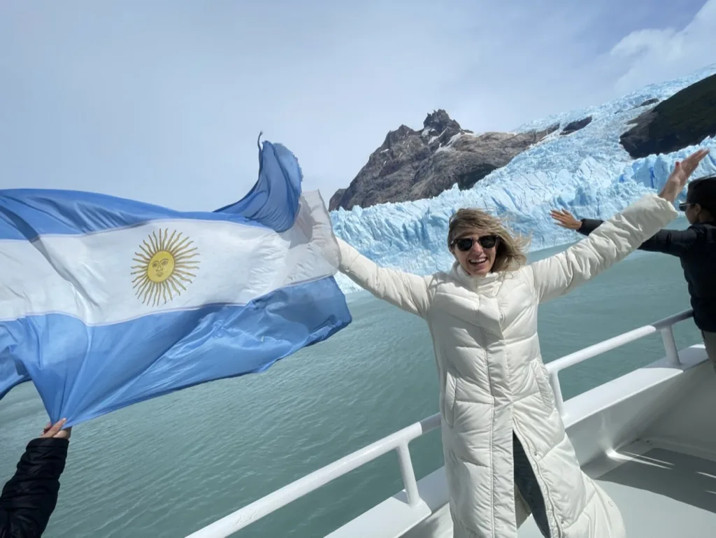 A traveler celebrating Patagonia with the Argentine flag on deck